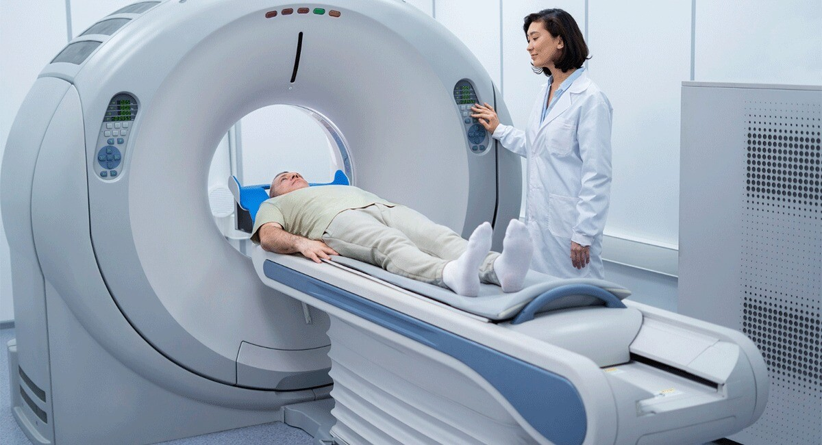 Patient undergoing an abdominal CT scan, lying on a scanning table as the machine captures images of internal organs for diagnosis.