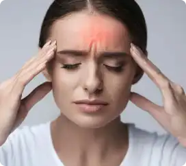 Woman touching her temples with a headache and forehead pain