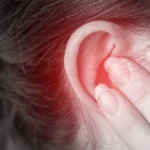 Ear pain and redness from possible ear infection.