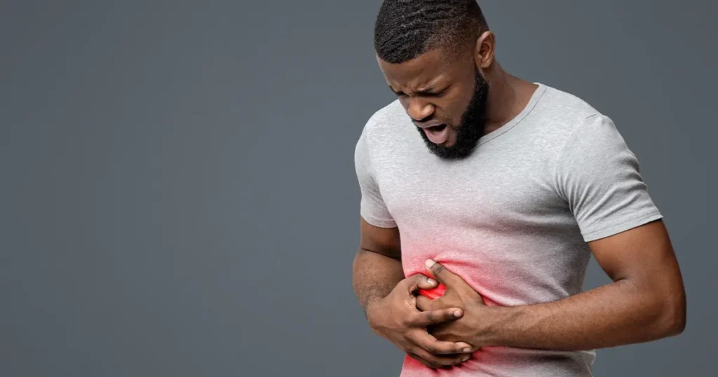 Man experiencing IBS-related abdominal pain