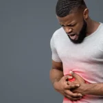Man experiencing IBS-related abdominal pain