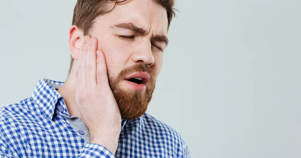 Man experiencing ear infection and sore throat pain.