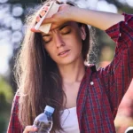 Woman suffering dehydration during hot weather.