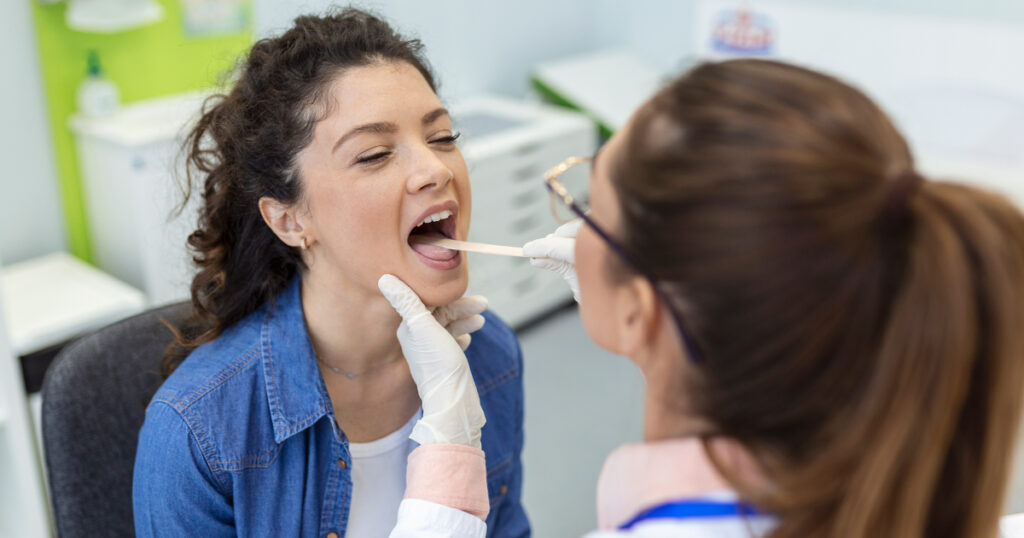 A woman is undergoing check-up with a doctor at Exceptional Emergency Centers.