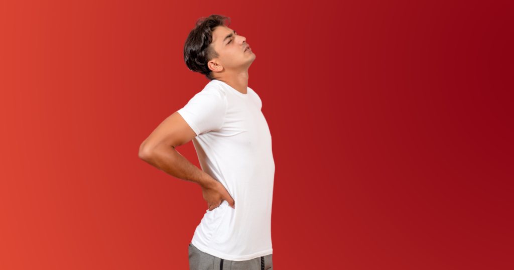Man holding his middle back in pain on a red background.