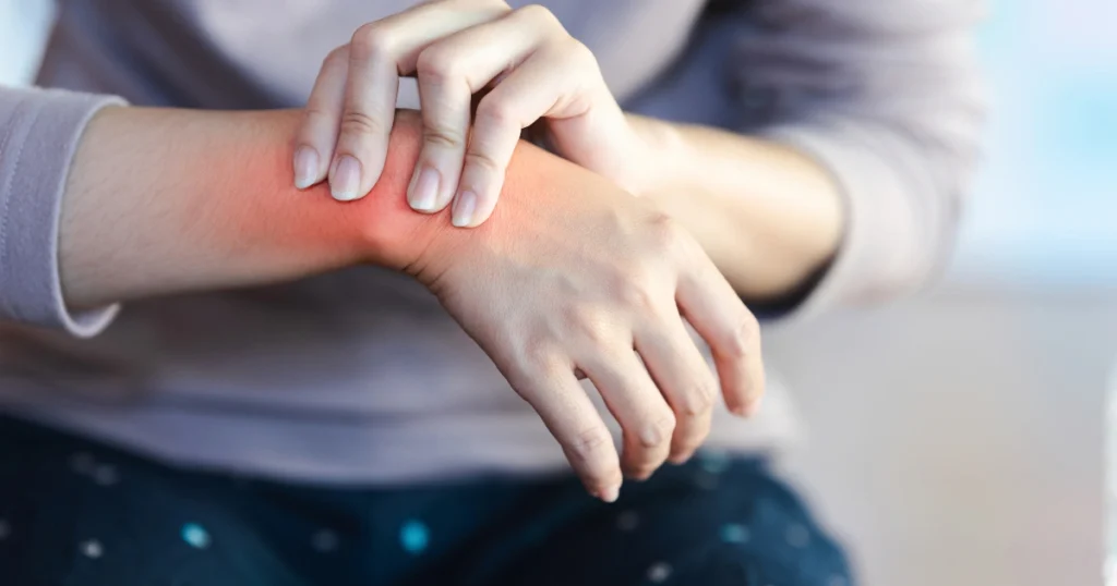 Woman holding painful wrist with pinched nerve
