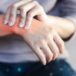 Woman holding painful wrist with pinched nerve
